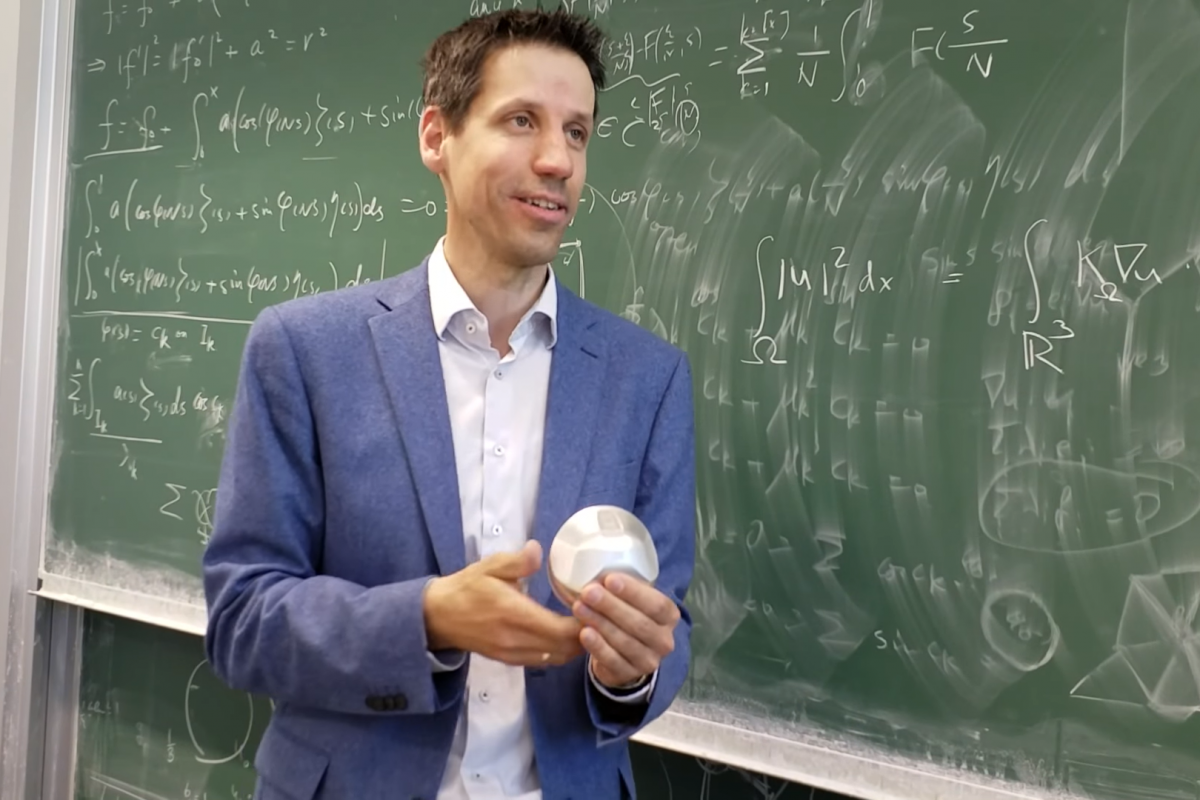 László Székelyhidi holding Gömböc 1409: "Gömböc fascinates me because it holds a universal property among all possible forms in space, and it was so difficult to find.", 2017.